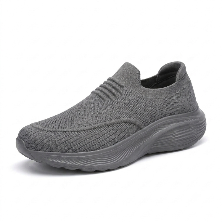 Grå slip-on komfortsko unisex med stötdämpande sula och stretchigt sticktyg mot vit bakgrund